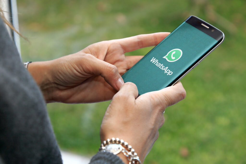 pessoa segurando celular, na tela o aplicativo Whatsapp - o impacto das fake news na sociedade